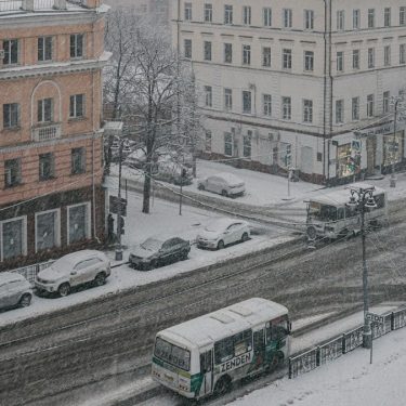 a couple of buses that are sitting in the snow
